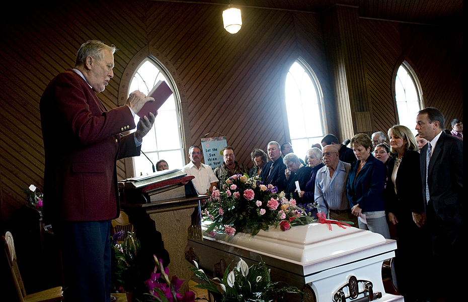 Pastor Ken Brand sings with the congregation during funeral services for Allaina Taylor at Ivanhoe Presbyterian Church in Lost City on Friday.