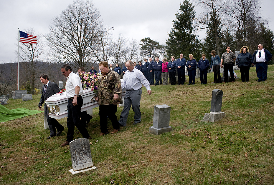 Pallbearers carry the casket of Allaina Taylor past members of the Mathias-Baker Rescue Squad during interment services at Laurel HIll Cemetery in Lost City on Friday.