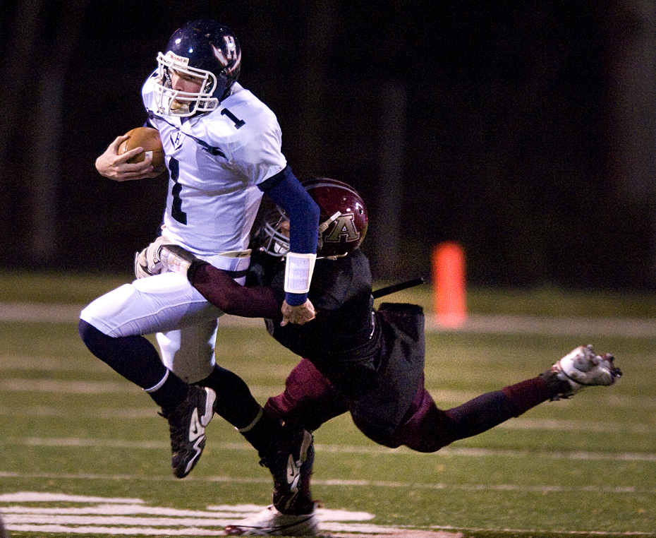 Harrisonburg High School quarterback Jake Johnson is caught from behind during  first quarter of the Region III, Division 4 championship game in Amherst Friday night. 
