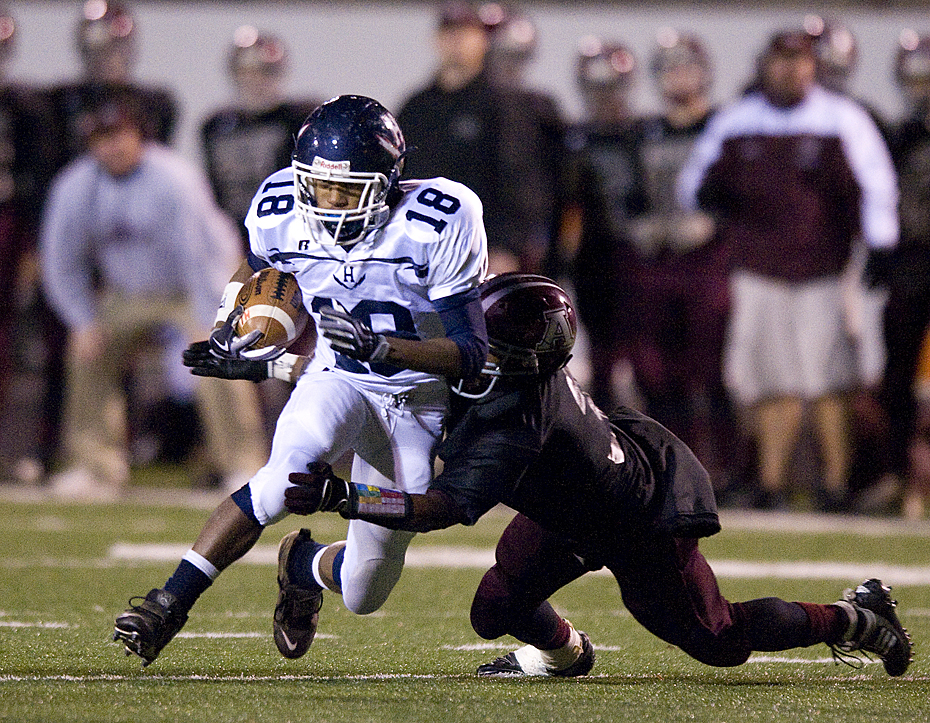 Harrisonburg's Troy Jones is tacked during first quarter action in the  regional final in Amherst Friday night.