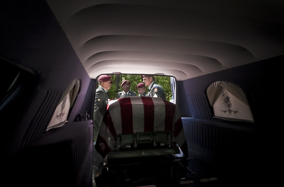 A honor guard removes the casket of Esau Patterson Jr. at the family cemetery in Ridgeland, SC. Patterson died in Baghdad, Iraq, when a vehicle approached his unit and the driver detonated a bomb. He was assigned to 4th Battalion, 27th Field Artillery Regiment, 1st Armored Division, Baumholder, Germany. Died on April 29, 2004.