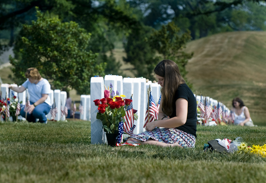 Amanda Lamb, 21, sits in front of a headstone in Section 60 of Arlington National Cemetery on Memorial Day weekend. The stone marks the grave of her best friend, U.S. Army Spc. Justin Allan Rollins, a member of the 82nd Airborne.Rollins, 22, died on March 5, 2007, when an improvised explosive device detonated near his convoy in Samarra, Iraq.