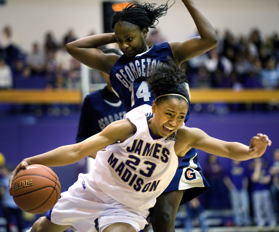 James Madison's Dawn Evans drives past Georgetown's Ta'Shauna Rodgers during first-half action at the JMU Convocation Center in Harrisonburg on Wednesday. JMU upset the Hoyas 79-76.
