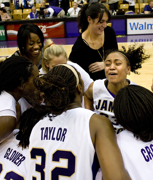 James Madison's Dawn Evans celebrates with her teammates following their upset over Georgetown at the JMU Convocation Center in Harrisonburg on Wednesday. JMU upset the Hoyas 79-76.
