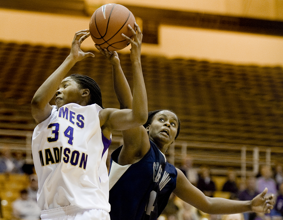 James Madison's Kiara Francisco battles for a rebound with Georgetown's Ta'Shauna Rodgers during second-half action at the JMU Convocation Center in Harrisonburg on Wednesday. JMU upset the Hoyas 79-76.