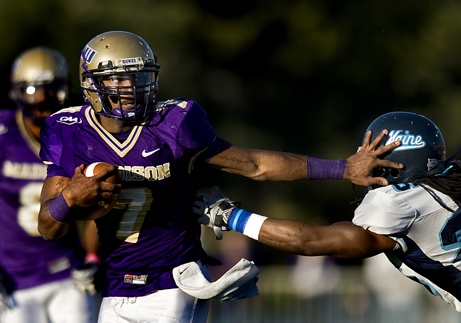 JMU quarterback Justin Thorpe brushes aside a defender on his way to a touchdown during second quarter action against Maine on Saturday.