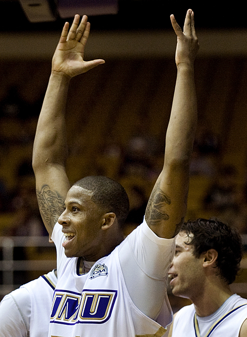 James Madison's Peirre Curtis celebrates his 1000th career point during first-half action against Norfolk State in Harrisonburg on Wednesday. JMU won the game 72-64.