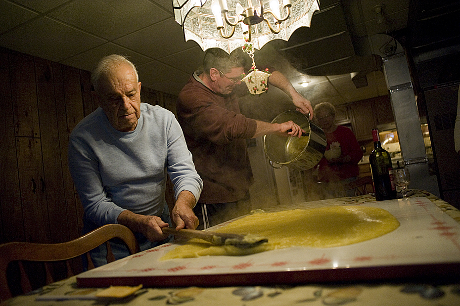 My uncle Fritz spreads the polenta on a large board on the table before the toppings are added.